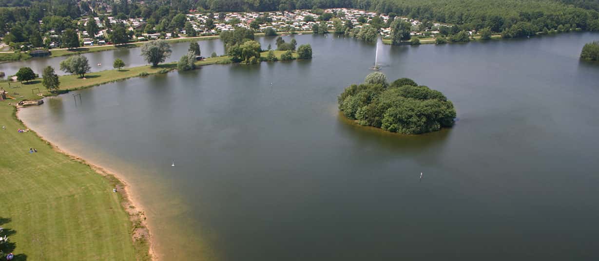 Aerial view of Lake Irenensee with beach and holiday park